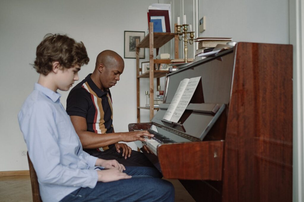 Child taking piano lesson at home