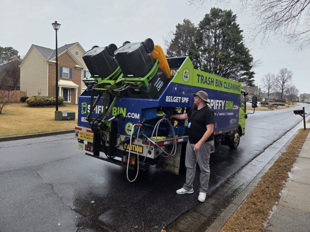 Trash bin cleaning truck servicing residential neighborhood in South. Forsyth, Georgia
