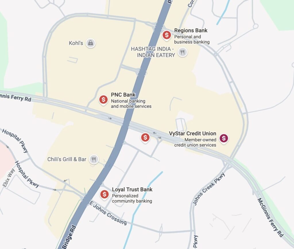 Map showing multiple bank locations clustered along GA-141 and McGinnis Ferry Road in Johns Creek, including PNC Bank, Regions Bank, VyStar Credit Union, and Loyal Trust Bank.