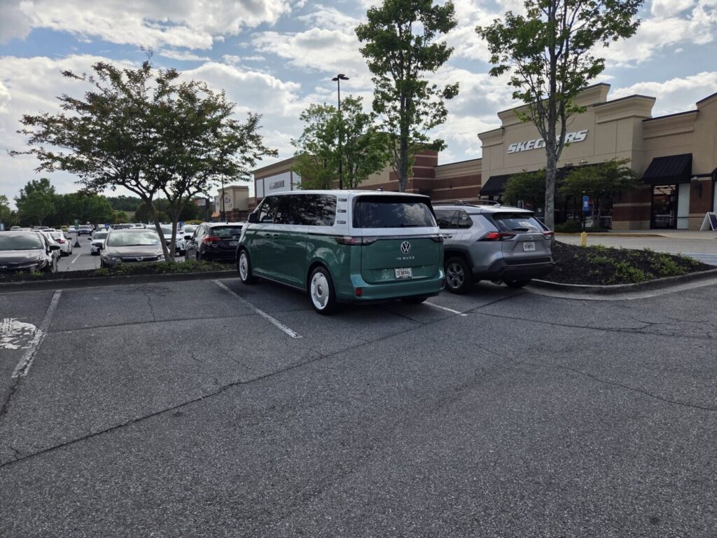 Suburban shopping center parking lot in Johns Creek area with wide, free parking spaces and retail storefronts in the background