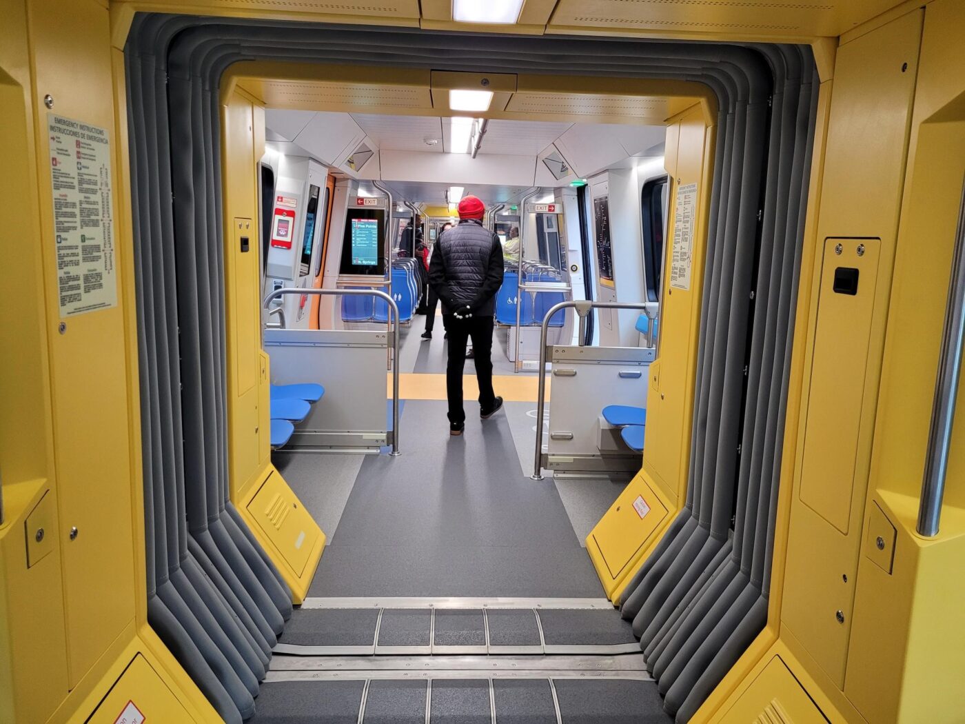 Interior view of a new MARTA CQ400 railcar showing the open gangway connection between train cars.