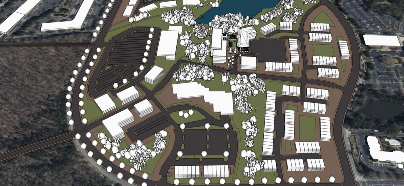 A site plan illustrates the scale and complexity of Deerfield redevelopment, where new connections may need to cross several properties. Aerial-style planning map with roads, buildings, trees and a water feature laid out across a large site.