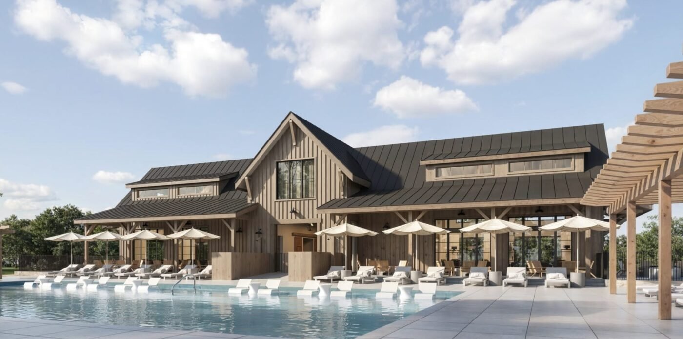 Amenity building and pool area with lounge chairs and umbrellas beside a modern clubhouse