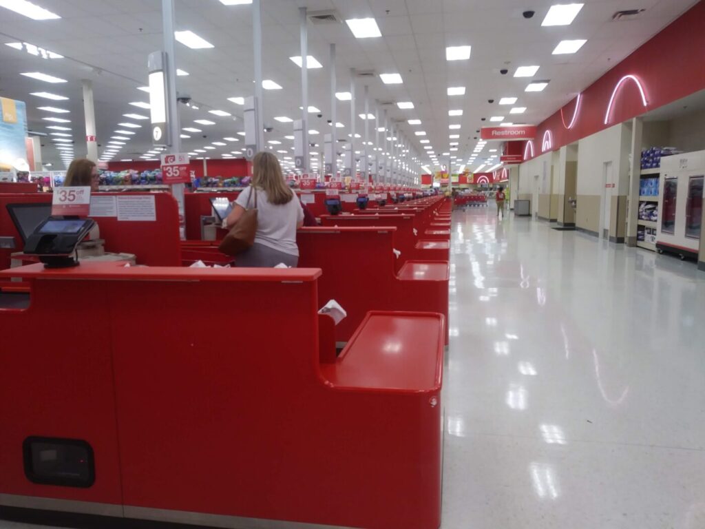 A long row of red checkout lanes inside a Target store