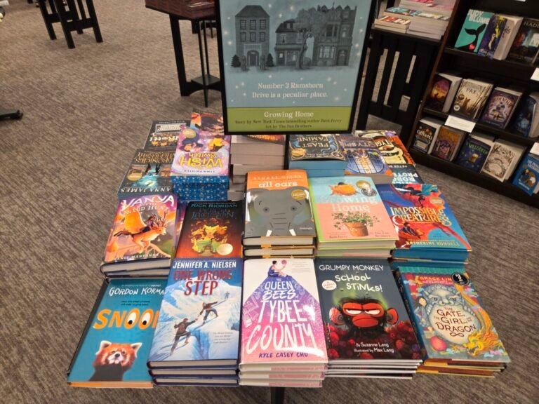 A display of colorful children’s books arranged on the floor inside a Barnes & Noble store