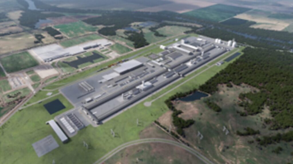 An aerial rendering shows a large industrial complex surrounded by fields and trees.