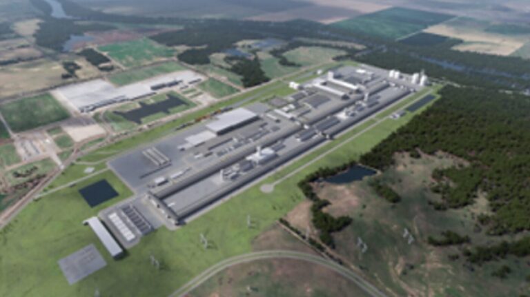 An aerial rendering shows a large industrial complex surrounded by fields and trees.