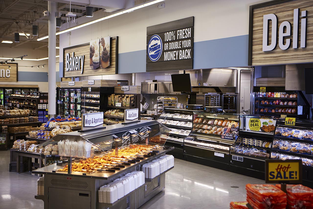 Bakery and deli area with prepared foods, baked goods and hot case displays
