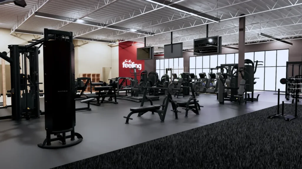 Empty Snap Fitness gym floor with weight machines, benches and cable stations under a high ceiling