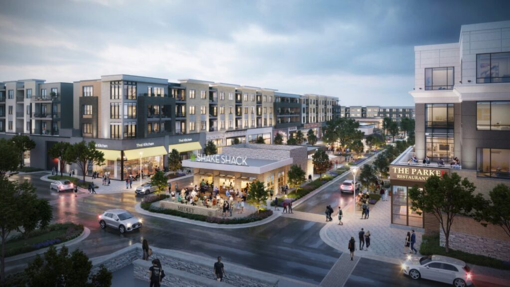 Architectural rendering of a mixed-use development with shops, restaurants and apartments surrounding a central plaza at dusk.
