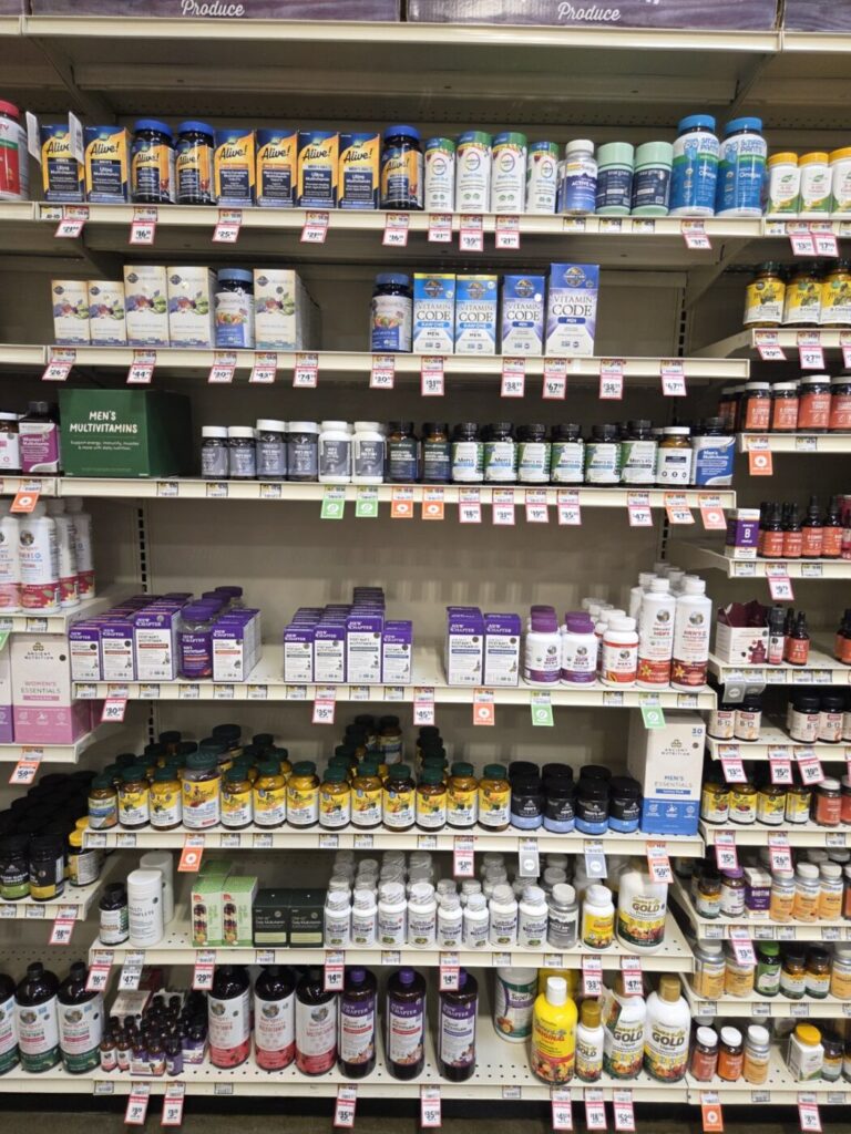 Store shelves stocked with multivitamins, herbal supplements and nutritional bottles