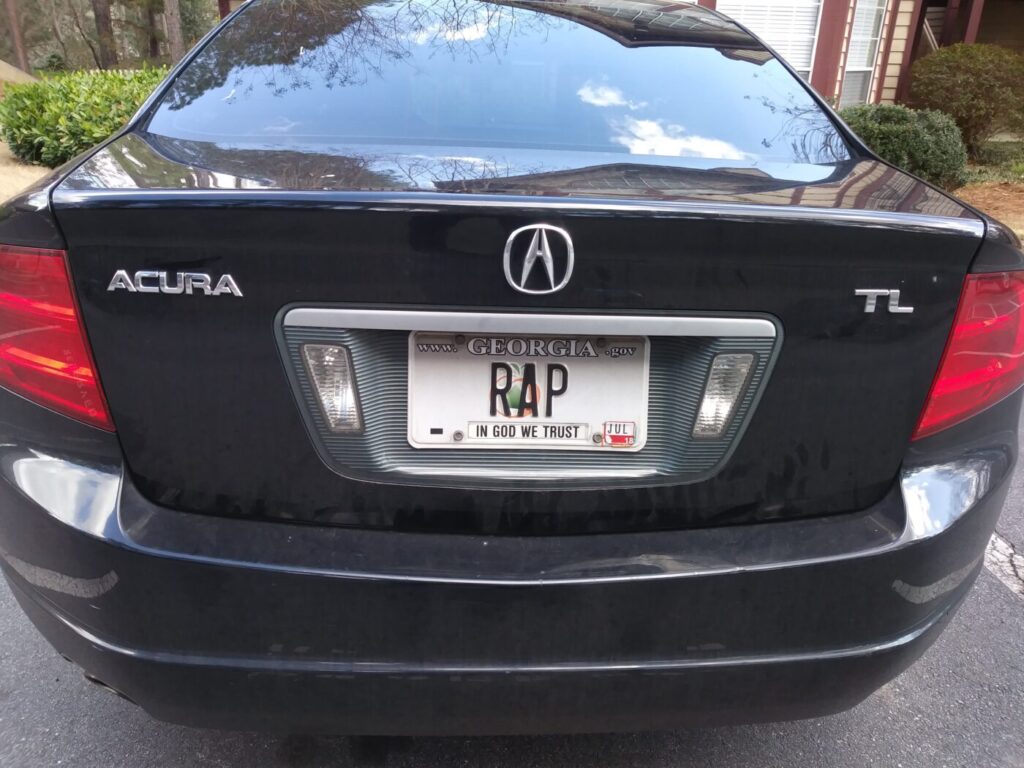 Rear of a black Acura TL with a Georgia vanity plate reading RAP.