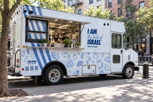 White A Taste of Israel food truck with blue lettering and an open serving window.