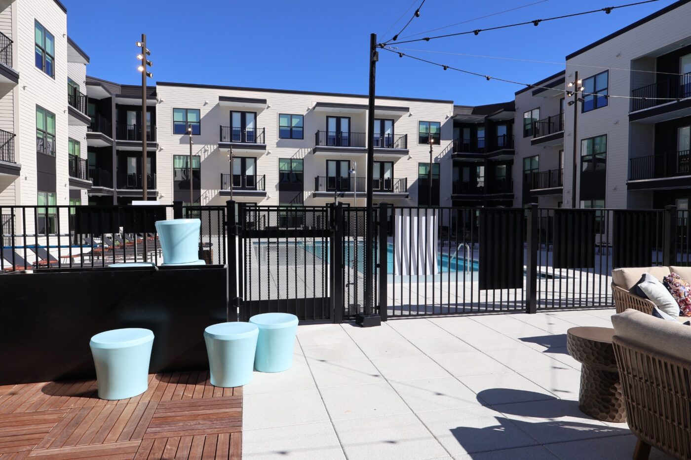 A fenced pool courtyard surrounded by Prelude apartment buildings.