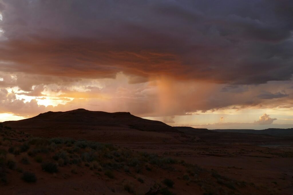 Illustrative photo of storm clouds over the Arizona landscape; not a photograph of the October 2026 storm.