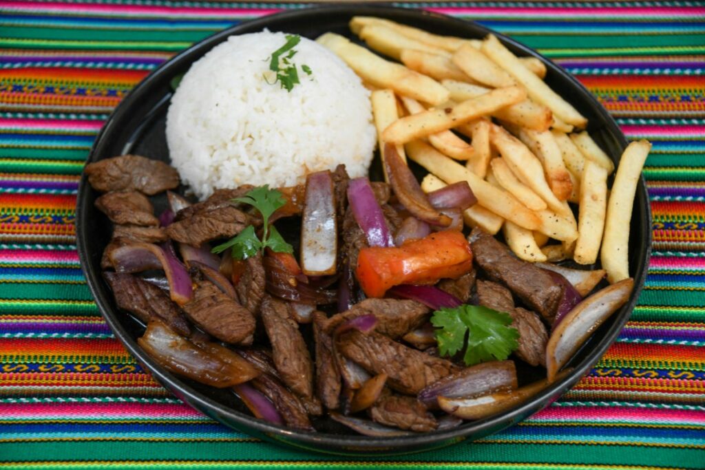 Lomo saltado with beef, onions, tomatoes, rice and fries at Cuzco Peruvian Cuisine
