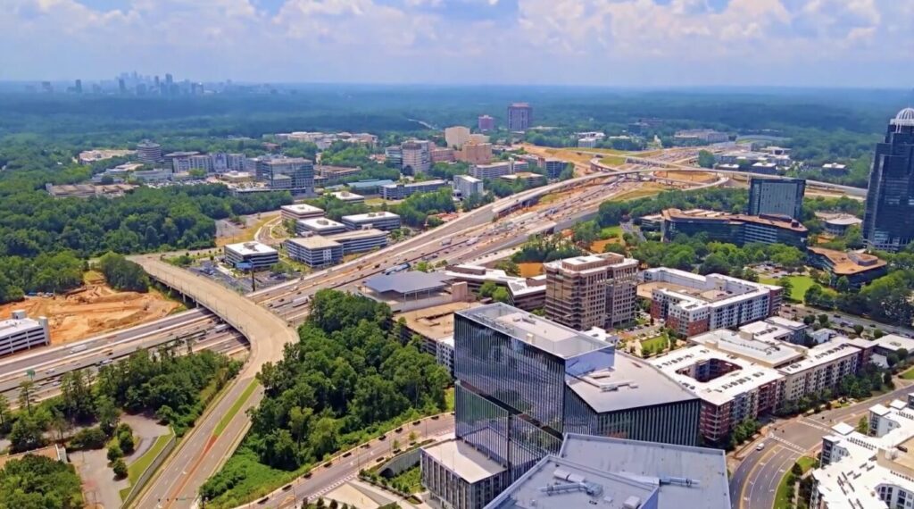 Aerial view of Dunwoody with highways, office buildings and dense tree cover