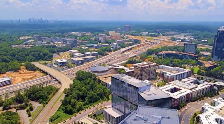 Aerial view of Dunwoody with highways, office buildings and dense tree cover