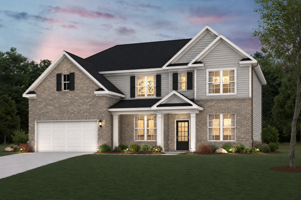 Two-story suburban house with a two-car garage, brick and siding exterior, and lit windows at dusk.