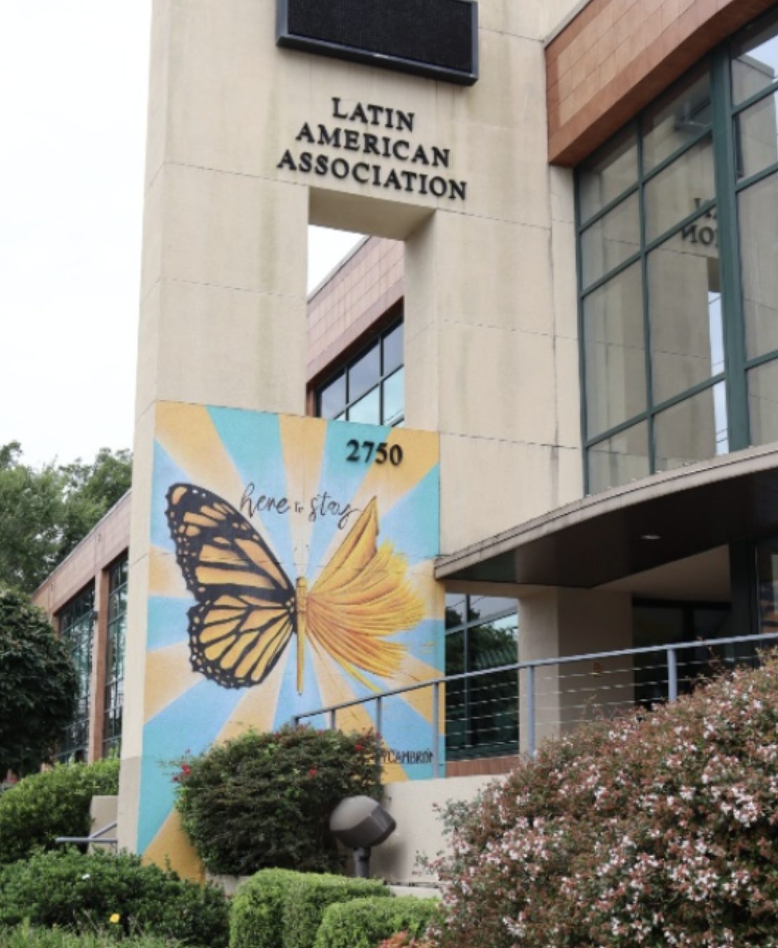 The Latin American Association building exterior with a butterfly mural and the address 2750 visible.