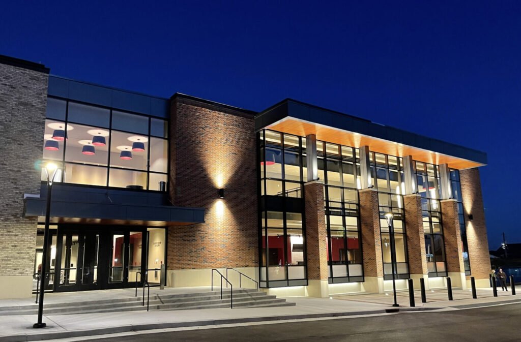 Lawrenceville Arts Center glows at dusk with lit windows and a brick facade.