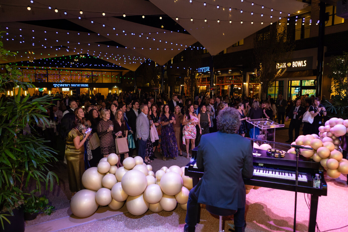 An audience gathers for an evening piano performance at Medley.
