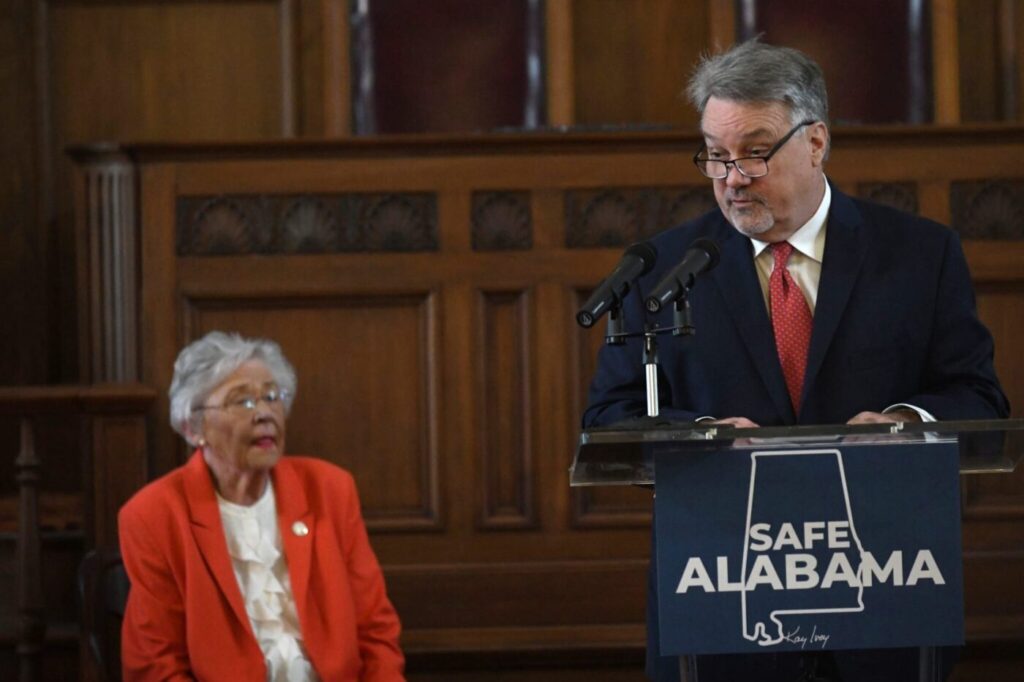 Alabama House Speaker Nathaniel Ledbetter speaks as Gov. Kay Ivey listens at a February 12, 2025 press conference in Montgomery.