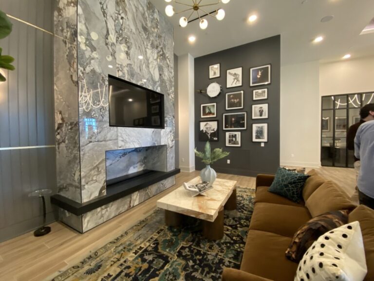 A sofa and music photographs beside the fireplace in Prelude’s lobby.
