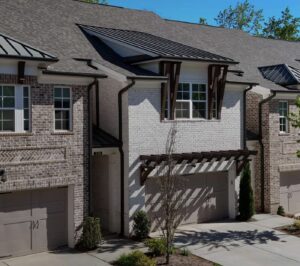 Row of newly built townhomes with garages and covered entry areas