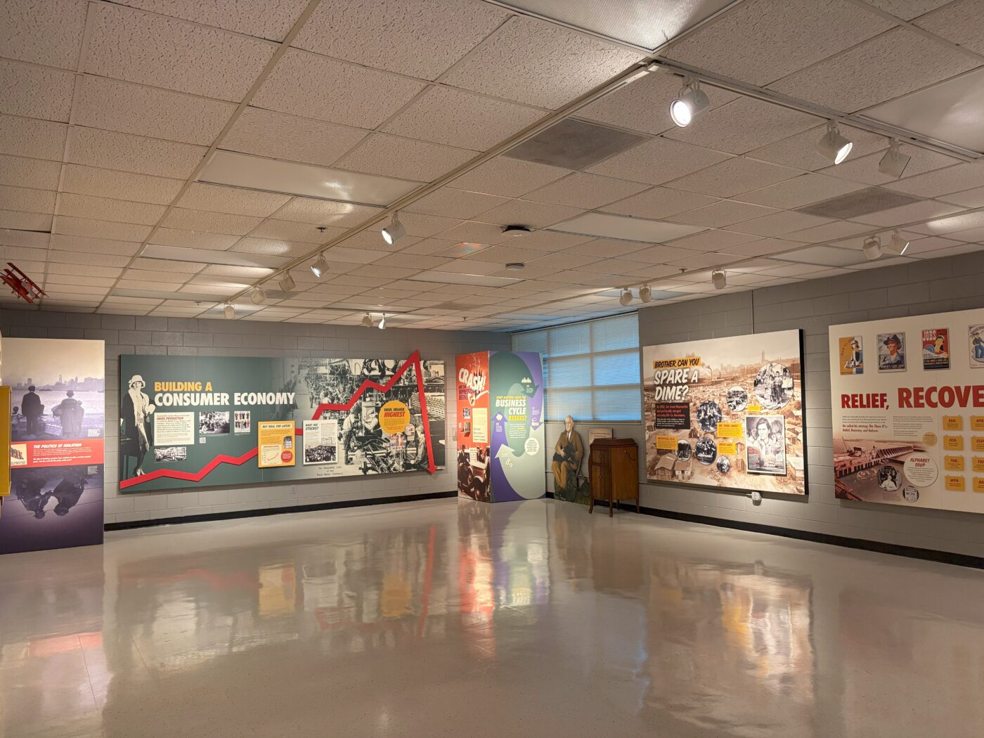 Historical photographs, infographics and artifacts in the Teaching Museum’s Great Depression display.